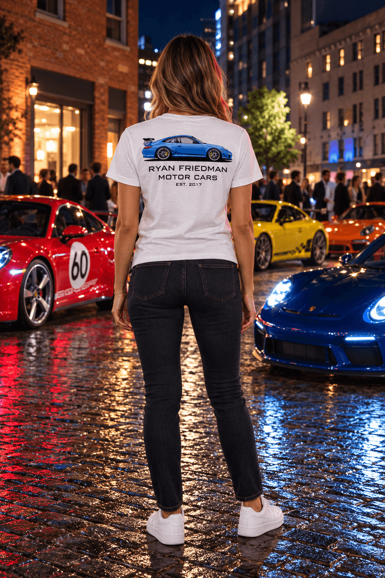 Woman wearing the Blue GT3 RS T-Shirt from behind, showing the back print, at a night car meet on a wet cobblestone street